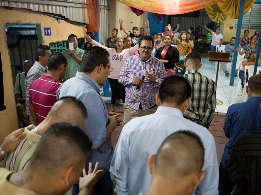 The Rev. Nelson Moz, churchgoers and ex-gang members pray together at Eben-ezer in San Salvador.