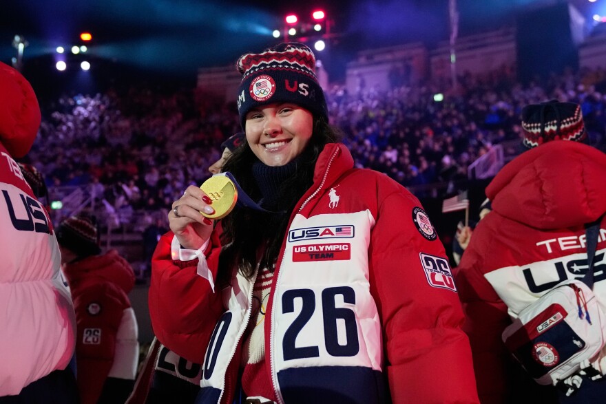 U.S. freestyle skier Kayla Kuhn poses with her gold medal at the closing ceremony of the 2026 Winter Olympics, in Verona, Italy, Sunday, Feb. 22, 2026.