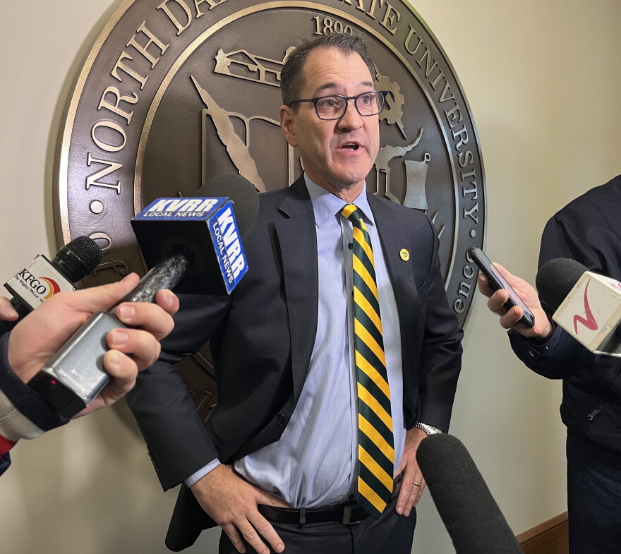 NDSU President Dr. David Cook speaks to reporters.
