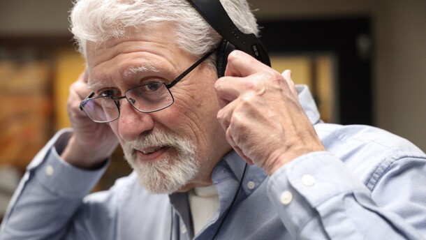 Alex Crichton puts on headphones as he prepares to host the local breaks during NPR’s “All Things Considered” on WXXI News on Monday, Feb. 9, 2026. His retirement will mark the end of a 45-year career in radio, including nearly 42 years at WXXI.