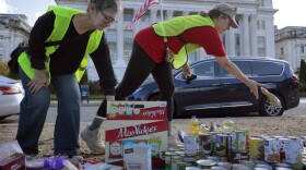 Volunteers organize donated beans, powered milk and other nonperishable items during a food drive in front of the U.S. Department of Agriculture on Thursday in Washington, D.C.