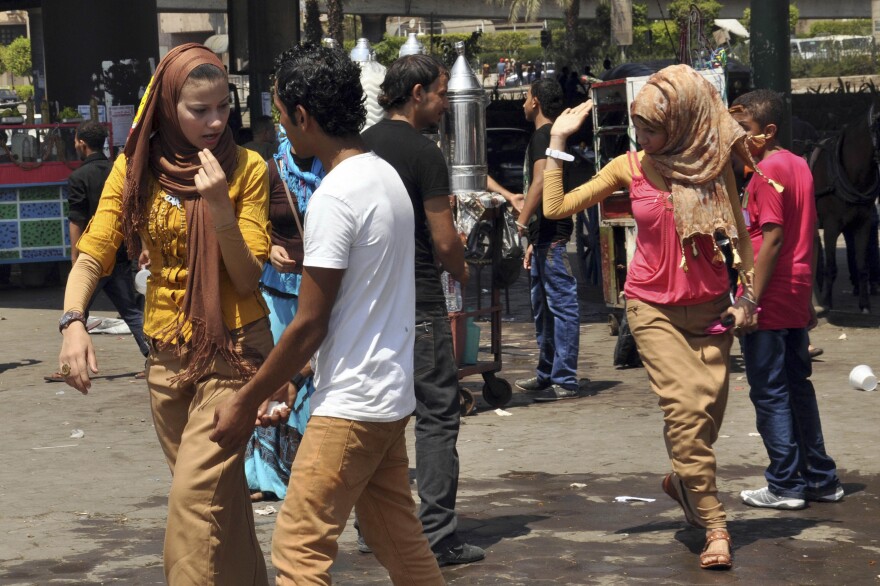 Young men harass women in Cairo. Such episodes surged during the Muslim holiday last month.