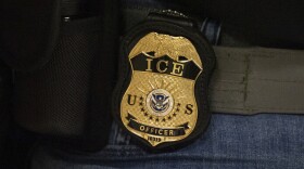 FILE - A federal agent wears an Immigration and Customs Enforcement badge in New York, June 10, 2025. (AP Photo/Yuki Iwamura, File)