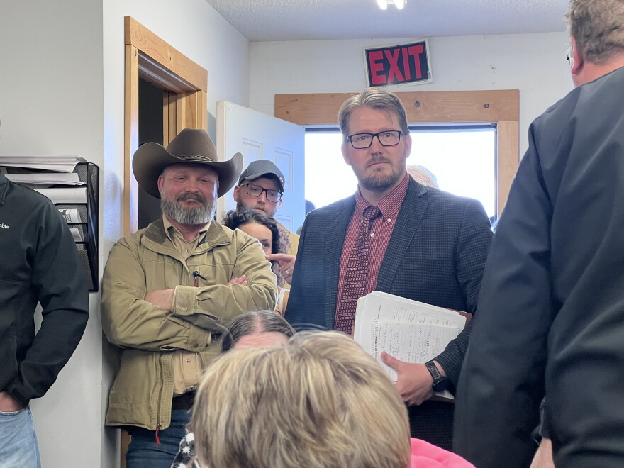Cass County Attorney Ben Lindstrom, right, stands next to Deputy Aaron Ammerman after presenting a request for board action to Cass County Board to require Ammerman take a leave of absence while he runs for sheriff. The meeting was May 19, 2026, at May Town Hall in rural Motley.