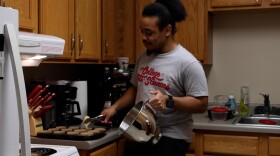 Christian Oates fills the cupcake liners with batter.