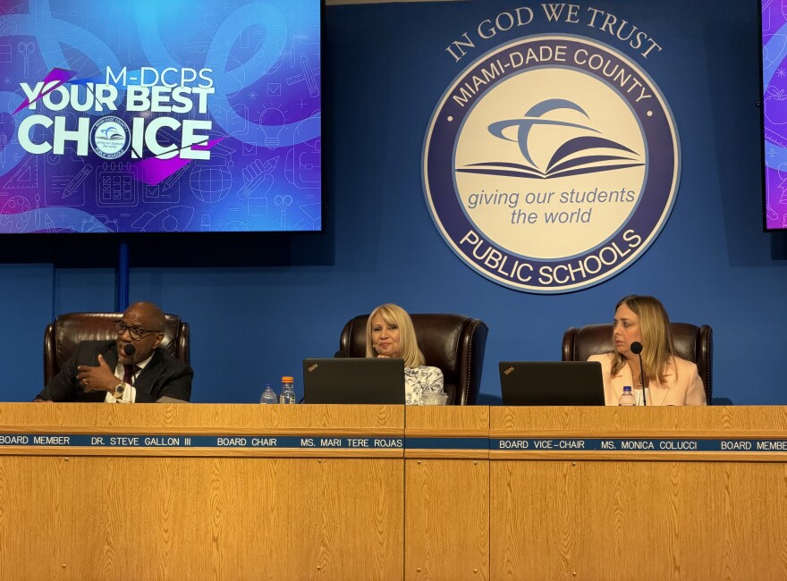 A close-up photo of Miami-Dade County school board members Steve Gallon III, Mari Tere Rojas and Monica Colucci on the dais.  