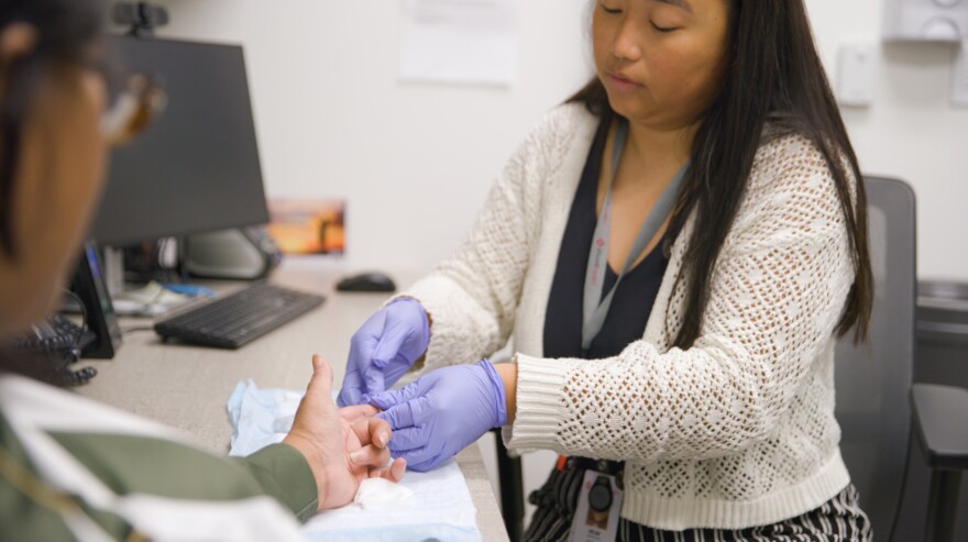 A Vivent Health professional conducts a test on a patient.