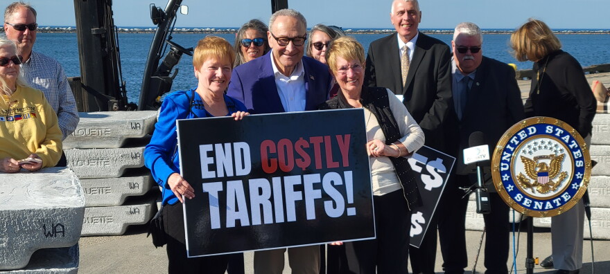 Sen. Chuck Schumer (D-NY) poses with participants at a press conference Oct. 29, 2026 at the Port of Oswego Authority focused on the damage done by President Trump's tariffs.