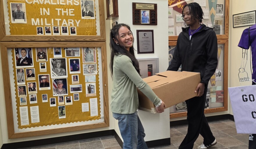 East Stroudsburg High School South students Mia Cabardo and Jahmere Grant carry a box of pants in the school's lobby on Friday. Members of the Key Club sorted 650 pairs of pants to distribute to area clothing closets.