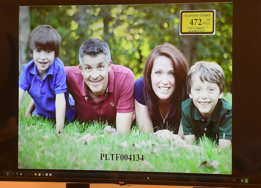 A photo of Ian and Nicole Hockley, and their sons Dylan, left, and Jake, is displayed for the jury panel during the Hockley's testimony in the Alex Jones defamation trial at Superior Court in Waterbury, Conn. on Tuesday, September 27, 2022.