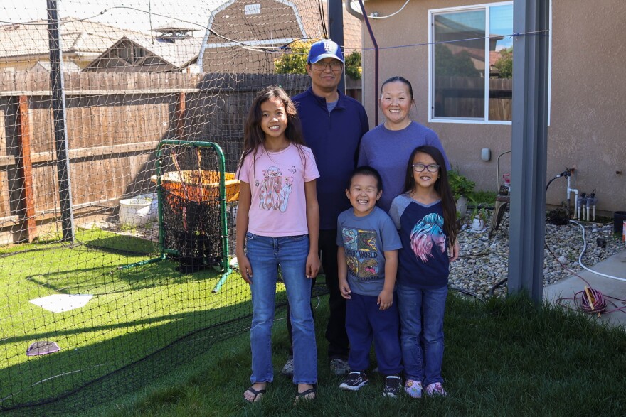 Luke Rou, center, stands from left with two of his sisters, Aubrey and Zoe, and parents Sam and Paule.