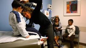 Physician's assistant Erin Frazier checks a young boy at a community health center for low-income patients in Lakewood, Colorado.