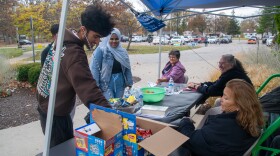 Voters at the McMillen Park polling place stop on their way out after voting to grab a couple snacks from the table set up by Count Us IN.