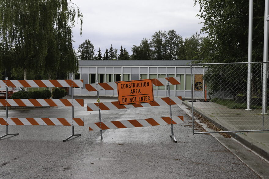 Orange construction area do not enter barricade positioned in front of a building
