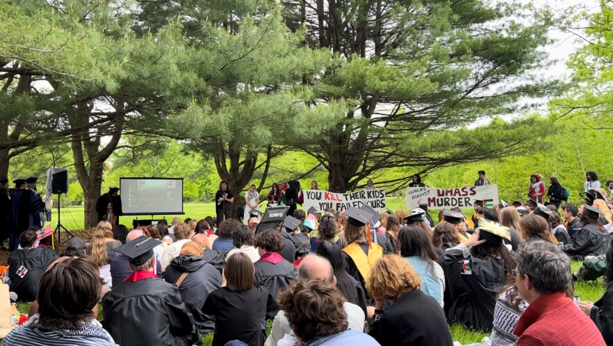 Dozens of UMass Amherst students and faculty members who walked out of Saturday's commencement ceremonies gathered a short distance outside of McGuirk Alumni Stadium, holding their own ceremony while continuing to call attention to the university's handling of pro-Palestinian demonstrations.