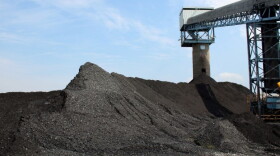 Illinois Basin coal piles up around Alliance Coal's conveyor belt at the Port of Mt. Vernon, waiting for transport on barges to regional power plants. - (File: IPB News)