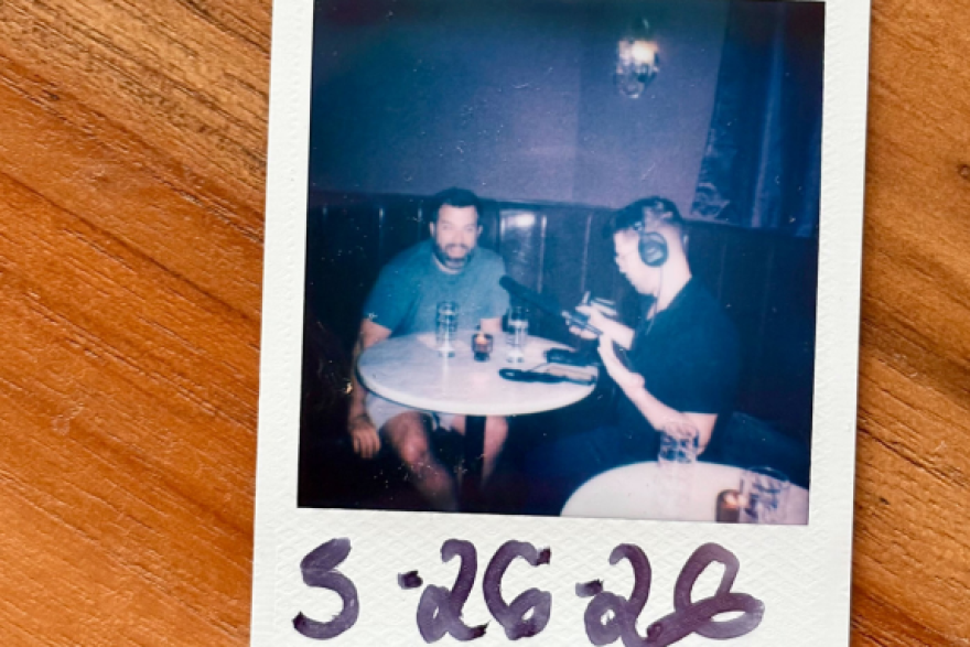 Every guest who visits Antagonist leaves with a Polaroid photo taken by staff. That includes WFAE’s Nick de la Canal, photographed mid-interview with bar co-owner Mike Salzarulo.