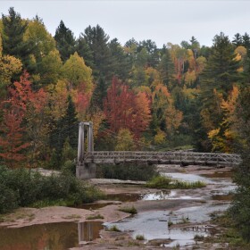 A suspension bridge over the Baltimore River near O-Kun-De-Kun Falls in the Ottawa National Forest.