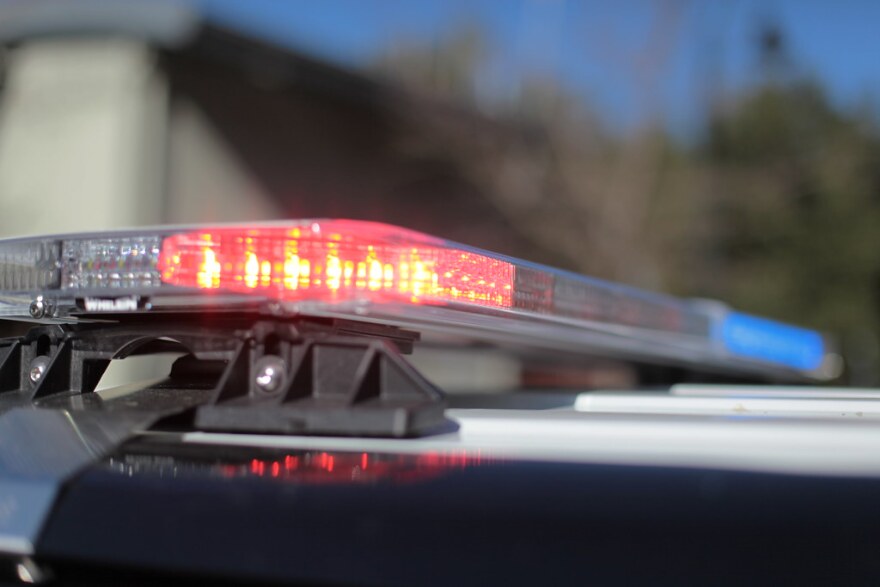 Red and blue lights flashing on top of a police car.