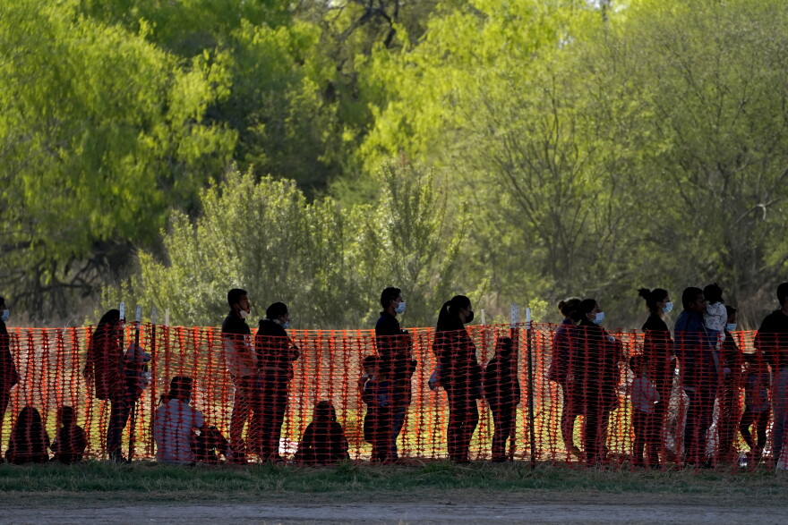 In this March 19, 2021, file photo, migrants are seen in custody at a U.S. Customs and Border Protection processing area under the Anzalduas International Bridge, in Mission, Texas. U.S. authorities say they picked up nearly 19,000 children traveling alone across the Mexican border in March. It's the largest monthly number ever recorded and a major test for President Joe Biden as he reverses many of his predecessor's hardline immigration tactics.