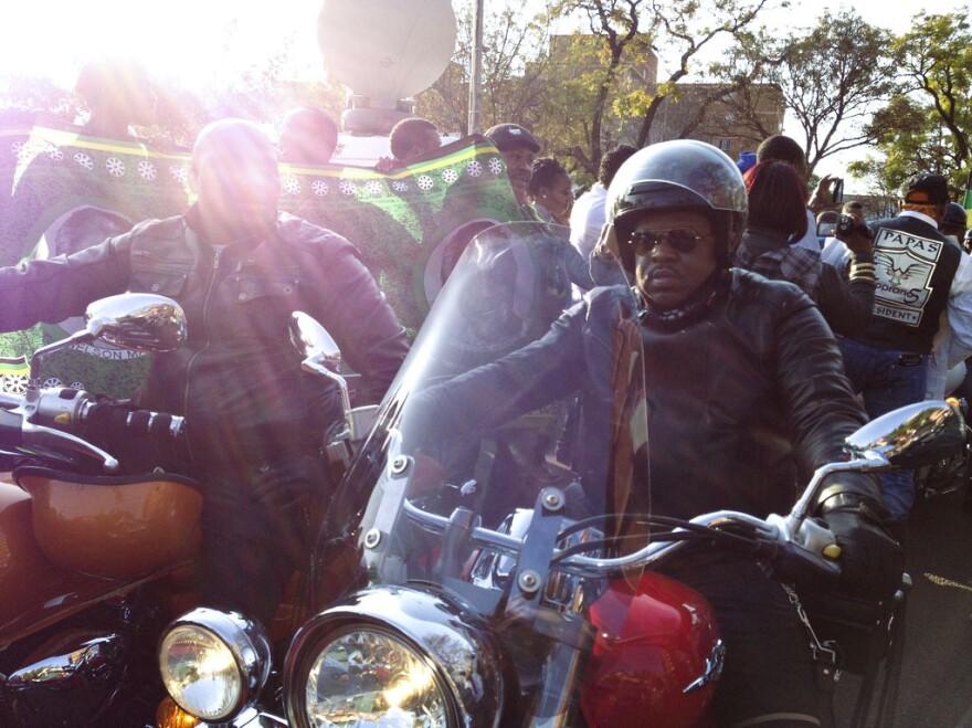 Members of a motorcycle club visit the makeshift memorial for Mandela outside his hospital.