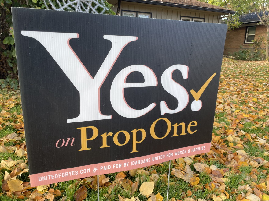 A close up of a political yard sign promoting the prop 1 ballot initiative, on a lawn strewn with fall leaves