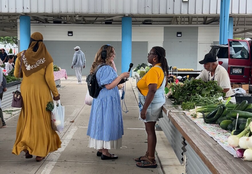 Lake Effect's Joy Powers chatting with Dig In! contributor Venice Williams at the Fondy Farmer's Market.