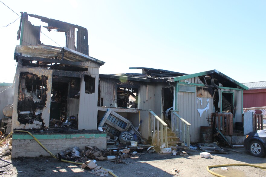 Fire hoses remain outside the burned-out remains of Kotzebue's Uutuku restaurant on June 3, 2026. The fire, ruled undetermined by investigators, destroyed the roughly 5,000-square-foot building.