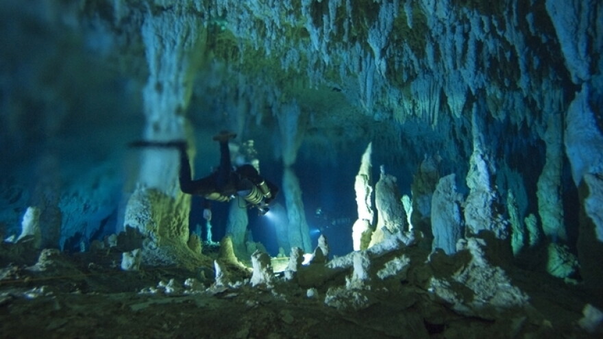 Kenny Broad negotiates the Cascade Room's stalagmites in Dan's Cave at Great Abaco Island, Bahama Islands.