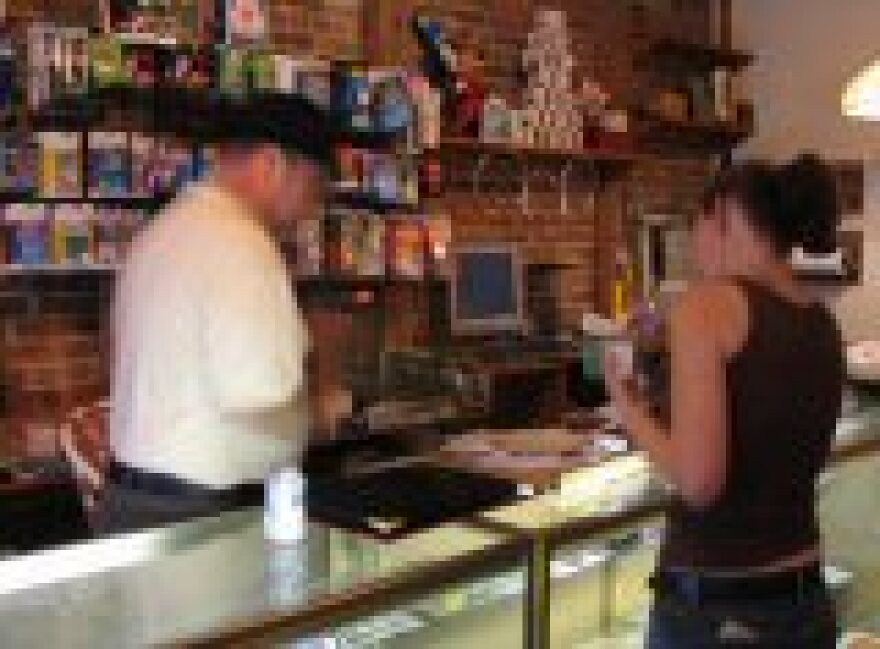 Roger Jones helping a customer in his Gotcha Magic Shop