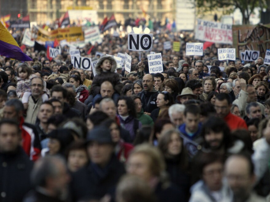 People march during a demonstration against health and education cuts recently announced by the Spanish government, in Madrid on Sunday.