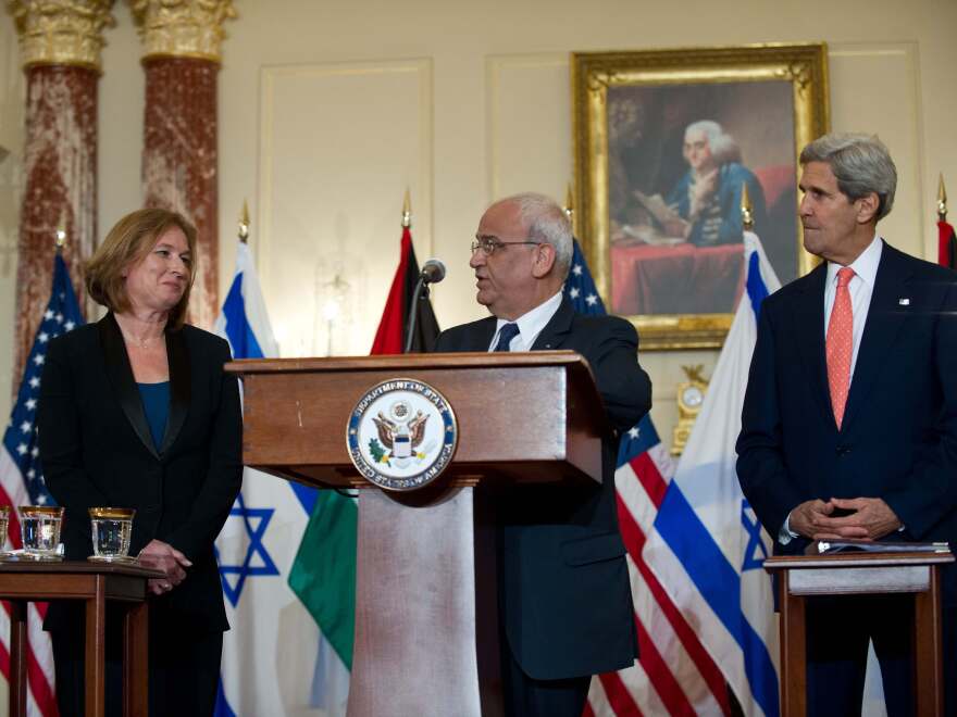 Chief Palestinian negotiator Saeb Erakat speaks to the media with Israel's chief negotiator and Justice Minister Tzipi Livni (left) and Secretary of State John Kerry in Washington on July 30.