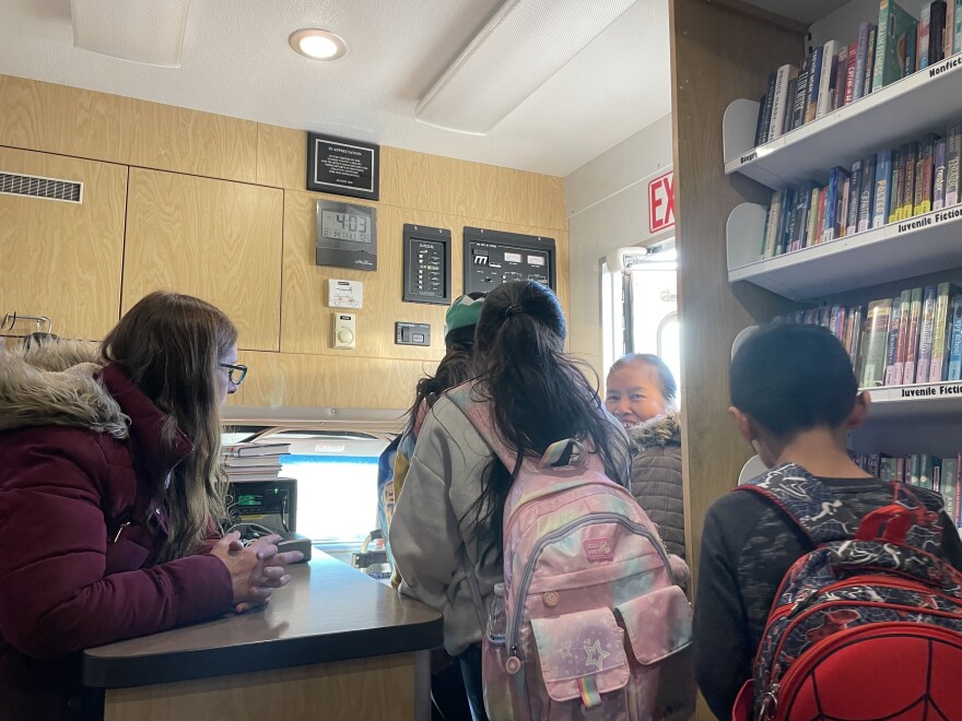 Librarian Linda Bliss welcomes visitors to the Bookmobile during its weekly visit to Hideout.