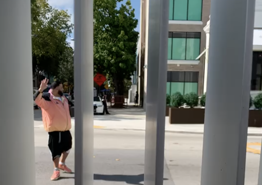 Screenshot of hip hop producer DJ Khaled walking away from Design and Architecture High School in Miami after he returned a lost ball back to DASH students.