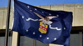 The Department of Labor seal on a flag flying outside the federal headquarters in Washington D.C.