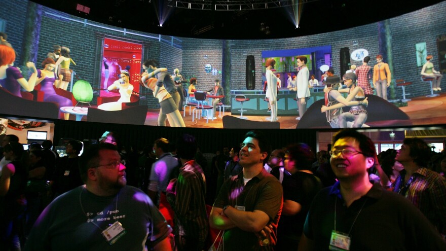 Visitors watch a demonstration of The Sims 2 at E3 on May 19, 2005. The Sims 2 is no longer commercially available on most platforms.