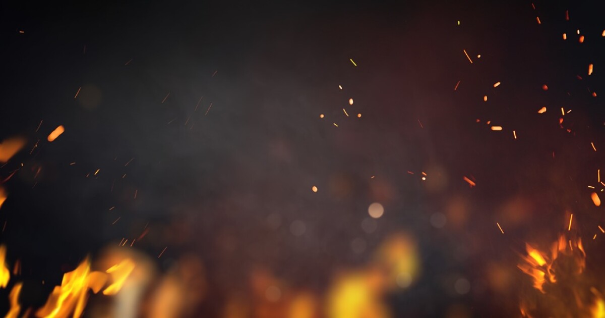 Flames and fire embers over a dark background