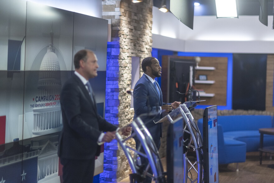 Charles Booker, right, speaks during a debate at the WKYT studios in Lexington, Ky., on Monday, Oct. 19, 2026.
