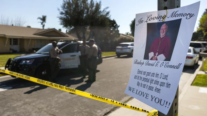 Sheriff's deputies guard the entrance to the street of Los Angeles Archdiocese Auxiliary Bishop David O'Connell's home in Hacienda Heights, Calif., on Sunday. The Los Angeles County Sheriff's Department says it has arrested the husband of O'Connell's housekeeper as a suspect in his death.