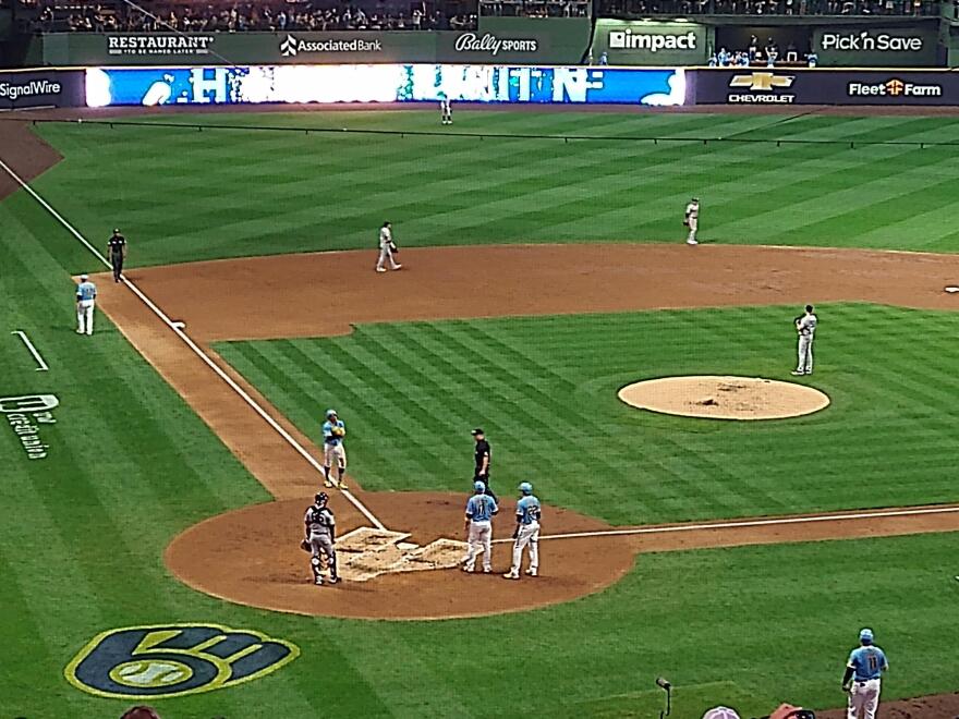 Brewers players wait to greet shortstop Willy Adames at home plate, after Adames homered against the New York Yankees on Sept. 17.