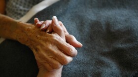 A terminally-ill resident of the Hospice of Saint John is comforted in her bed.  (John Moore/Getty Images)