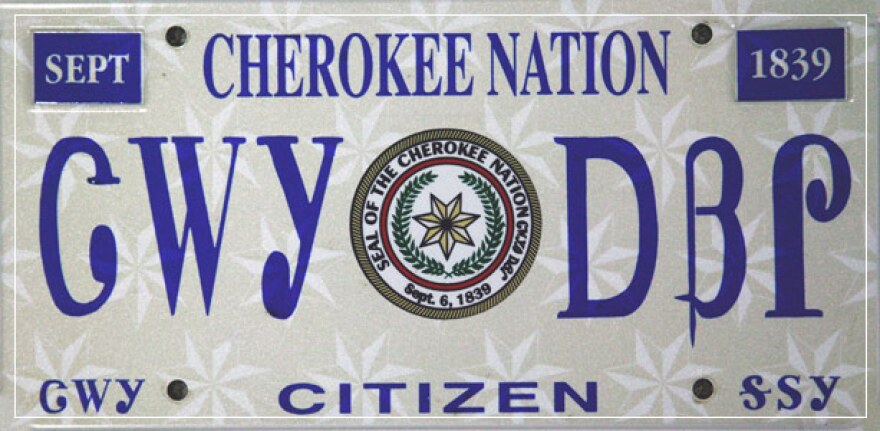 Decorative front plate from the Cherokee Nation that reads "Cherokee Nation" in Cherokee syllabary