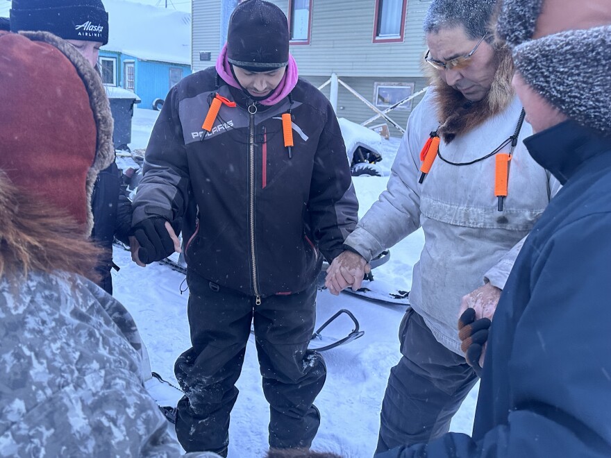 The travelers hold hands in a prayer before their trip.