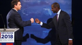 In this Oct. 24, 2018, photo, Florida gubernatorial candidates, Republican Ron DeSantis, left, and Democrat Andrew Gillum fist bump after a debate at Broward College in Davie, Fla. The final stretch of the midterm campaign is increasingly dominated by debate over one of the most sensitive issues in American political culture: Race. In Florida, accusations of racism are playing a central role in the hotly-contested campaign for governor. DeSantis chafed at questions about his ties to supporters who have made inflammatory comments. (AP Photo/Wilfredo Lee, Pool)