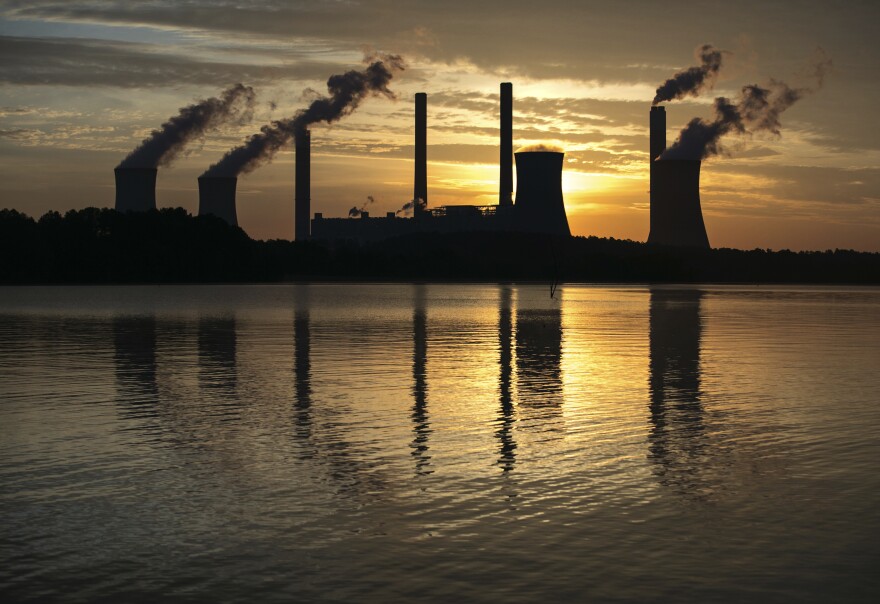 A coal-fired energy plant is seen at  sunset.