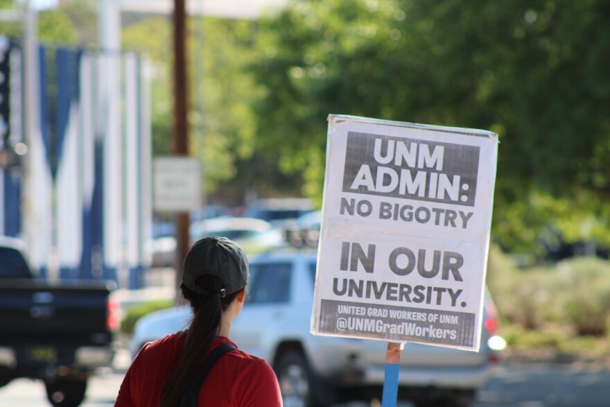 Protestor at picket holds up sign