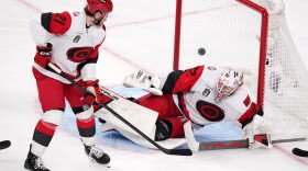 Carolina Hurricanes goaltender Brandon Bussi, right, is scored on by Carolina Hurricanes left wing Nikolaj Ehlers as defenseman Alexander Nikishin watches during the second overtime in Game 3 of the NHL hockey Stanley Cup Final series Saturday, June 6, 2026, in Las Vegas.