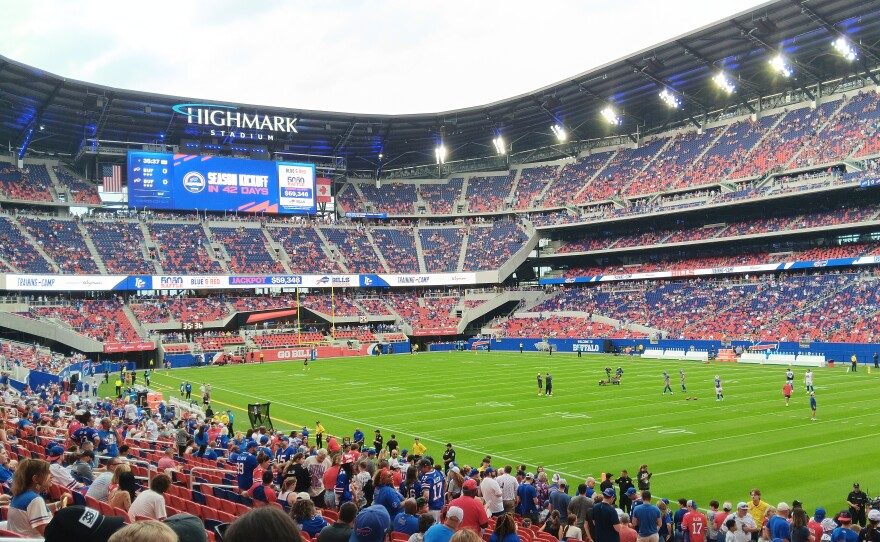 A handful of Buffalo Bills players and personnel are seen on the field as fans arrive in their seats Saturday, August 8, 2026, prior to the start of the Buffalo Bills 'Return of the Blue and Red' practice, the first public event to be held in the new Highmark Stadium.