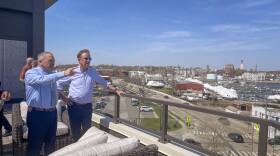 With New London mayor Michael Passero (left), Ned Lamont takes in a view of New London from a terrace at The Beam apartment building April 14, 2023.