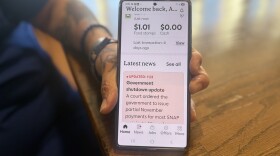 Ana Harris holding her phone showing the balance in her food stamp account on Nov. 6, 2025. She was stuck in Denver, unable to access the resources at her home in Silt, while her son received treatment for leukemia.